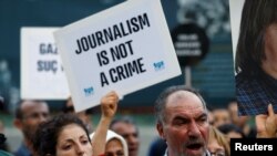 FILE - Demonstrators shout slogans during a protest against the arrest of three prominent activists for press freedom, in central Istanbul, Turkey, June 21, 2016. 