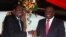 Zimbabwe President Robert Mugabe jokes with Prime Minister Morgan Tsvangirai, Harare, May 22, 2013.