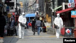 Quarantine workers spray disinfectants at night spots of Itaewon neighborhood, following the coronavirus disease (COVID-19) outbreak, in Seoul, South Korea, May 11, 2020.