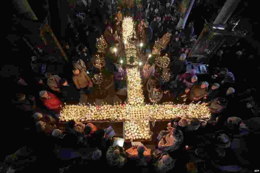 Worshippers gather around a cross during Mass for the &#39;sanctification of honey&#39; at the Presentation of the Blessed Virgin church in the town of Blagoevgrad, some 100 km (62 miles) south of the Bulgarian capital of Sofia.