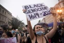 Demonstrators protest Friday, June 5, 2020, near the White House in Washington, over the death of George Floyd, a black man who was in police custody in Minneapolis. Floyd died after being restrained by Minneapolis police officers.