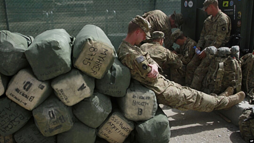 Tentara AS menunggu pemeriksaan barang-barang di luar kantor pabean Afghanistan di pangkalan Bagram, sebelum meninggalkan Afghanistan untuk kembali ke Amerika (14/7). 