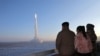 (FILES) This undated picture released by North Korea's official Korean Central News Agency (KCNA) on December 19, 2023 shows North Korean leader Kim Jong Un (L) and his daughter watching the test launch of a Hwasongpho-18 intercontinental ballistic missil
