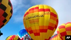 Hot air balloons are inflated during the annual Albuquerque International Balloon Fiesta in Albuquerque, N.M., Oct. 5, 2019. 
