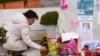 A woman prays at the statue of John Paul II outside the Gemelli Hospital where Pope Francis is hospitalized with pneumonia, in Rome, Italy, March 9, 2025. 