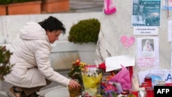 A woman prays at the statue of John Paul II outside the Gemelli Hospital where Pope Francis is hospitalized with pneumonia, in Rome, Italy, March 9, 2025. 