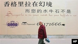 A Chinese man walks past a billboard for a new commercial development which reads ‘Shangrila is in your mind but your buffalo is not’ in Beijing (file photo)