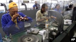 FILE - Diamonds are polished at the Krochmal and Cohen diamond factory in Johannesburg.