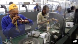 FILE - Diamonds are polished at the Krochmal and Cohen diamond factory in Johannesburg. South Africa has launched an association for young, mainly black entrepreneurs to boost the processing and manufacturing of rough diamonds.