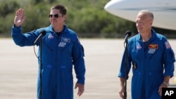 NASA astronauts Robert Behnken , left, and Doug Hurley take part in a news conference after they arrived at the Kennedy Space Center in Cape Canaveral, Fla., Wednesday, May 20, 2020. (AP Photo/John Raoux)