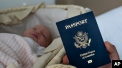 In this photo taken on Jan. 24, 2019, Denis Wolok, the father of 1-month-old Eva, shows the child's U.S. passport during an interview with The Associated Press in Hollywood, Fla. 