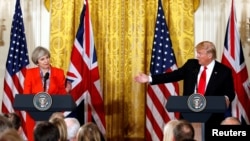 British Prime Minister Theresa May listens as U.S. President Donald Trump speaks during their joint news conference at the White House in Washington, Jan. 27, 2017. 