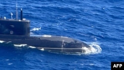 This handout photo taken on November 28, 2024 received on December 2, 2024 from the Armed Forces of the Philippines shows an aerial shot from an Armed Forces of the Philippines surveillance plane of a Russian Kilo-class submarine UFA 490 in the disputed South China Sea.