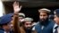 FILE - Police officers escort Zakiur Rehman Lakhvi, center, the main suspect of the Mumbai terror attacks in 2008, after his court appearance in Islamabad, Pakistan, Jan. 1, 2015.