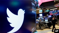 FILE - The logo for Twitter is displayed above a trading post on the floor of the New York Stock Exchange, Feb. 8, 2018. 