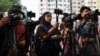 FILE - Journalists cover a protest in front of the National Press Club in Dhaka, Bangladesh, March 30, 2023.