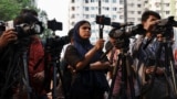 FILE - Journalists cover a protest in front of the National Press Club in Dhaka, Bangladesh, March 30, 2023.