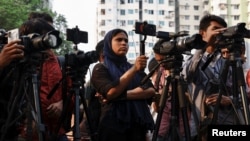 FILE - Journalists cover a protest in front of the National Press Club in Dhaka, Bangladesh, March 30, 2023.