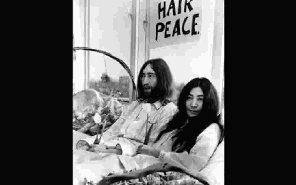 ** FILE ** Beatle John Lennon and his wife, Yoko Ono, right, hold a bed-in for peace in room 902, the presidential suite at the Hilton Hotel in Amsterdam on March 25, 1969. The newlyweds, holding solitary tulips, begin a seven-day Love-In to protest again