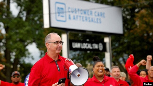 FILE - Shawn Fain, president of the United Auto Workers, speaks on the picket line in Belleville, Michigan, on Sept. 26, 2023. Union workers at Ford on Nov. 18 joined those at General Motors and Stellantis in approving new contracts with the automakers.