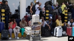 Stranded passengers waiting for their flights out of JKIA airport in Nairobi, Kenya, March 6, 2019. 