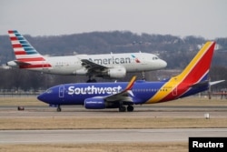 FILE PHOTO: An American Airlines aircraft lands at Reagan National Airport in Arlington, Virginia