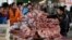 Meat stalls are seen at a market in Beijing, China, March 25, 2016. An exodus of small pig farmers in China is prolonging an industry downturn that will see the world's biggest pork producer and consumer challenge Japan as the top importer in 2016 for the first time.