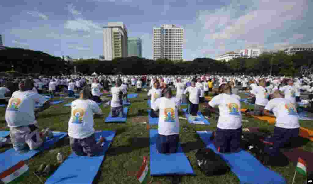 Thousands of people participate in a yoga exercise at Chulalongkorn University field, marking the International Day of Yoga in Bangkok, Thailand, Sunday, June 21, 2015. India's Prime Minister Narendra Modi called for a day dedicated to yoga when he addre