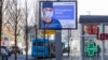 An electronic billboard showing a doctor wearing a protective mask, with the words next to him reading "Stay home; it will save a life," is seen in a street in Moscow, Russia, March 25, 2020. 