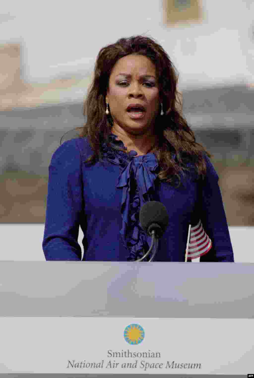 Opera Singer Denyce Graves sings the National Anthem at a ceremony commemorating the transition of space shuttle Discovery to the Smithsonian National Air and Space Museum at the Steven F. Udvar-Hazy Center. (NASA/Paul E. Alers)