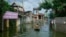 A man paddles a boat through flooded village in Chuong My district, Hanoi, Vietnam, July 31, 2018.