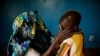 A mass rape victim comforts her son in the town of Fizi, Democratic Republic of Congo, February 20, 2011