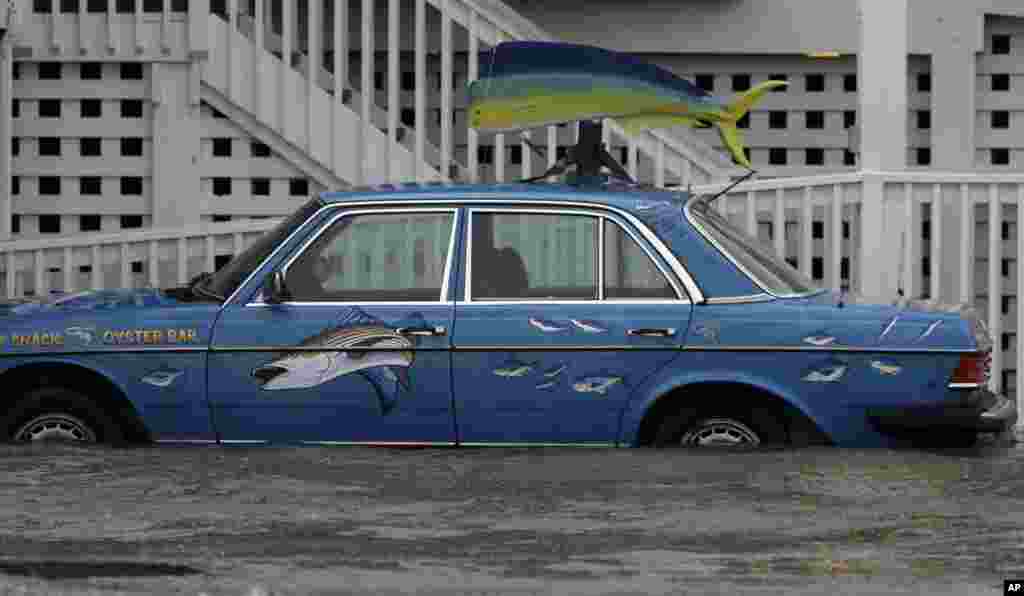 A vehicle sits in rising waters as Hurricane Arthur passes through the area in Nags Head, North Carolina, July 4, 2014.