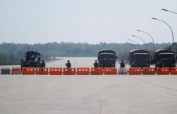 Soldiers stand guard at a Myanmar's military checkpoint on the way to the congress compound in Naypyitaw, February 1, 2021.