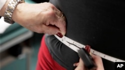 FILE - A subject's waist is measured during an obesity prevention study in Chicago on Jan. 20, 2010. (AP Photo/M. Spencer Green, File)