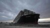 En esta foto entregada por la autoridad del Canal de Suez, se ve a remolcadoras trabajando para liberar al encallado carguero Ever Given, el domingo 28 de marzo de 2021.