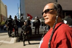 FILE - In this Saturday, Oct. 6, 2007 file photo, American Indian Movement activist Russell Means looks at the start of the Columbus Day Parade in Denver, Colo.