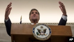 U.S. Secretary of State John Kerry, gestures during a press conference before heading to Jordan, following a day of meetings in Vienna, Oct. 23, 2015.