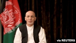 FILE- Afghan President Ashraf Ghani makes an address about the latest developments in the country from exile in United Arab Emirates, in this screen grab obtained from a social media video on Aug. 18, 2021.