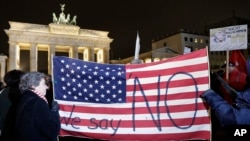 Protesters attend an anti-Trump rally in front of the Brandenburg Gate in Berlin, Germany, Jan. 20, 2017. 