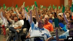 Members attending the Southern Baptist Convention vote to formally condemn the political movement known as the "alt-right," in a national meeting, June 14, 2017, in Phoenix.