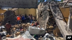 Residents sift through rubble from a destroyed building at the scene of an airstrike in Mekelle, in the Tigray region of northern Ethiopia, Oct. 28, 2021.