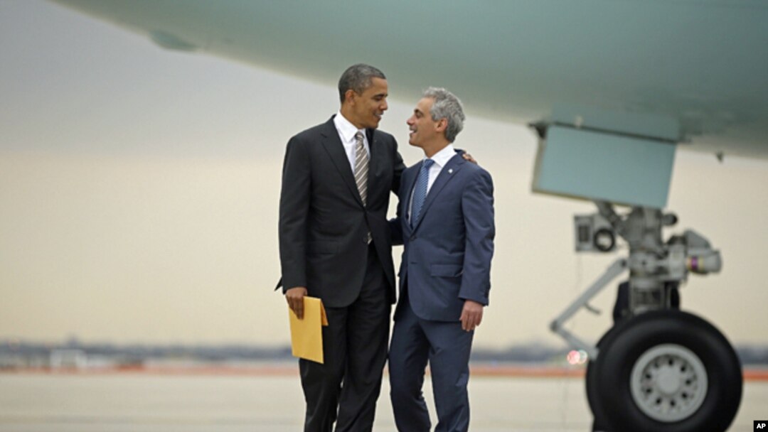 President Barack Obama is greeted by Chicago Mayor Rahm Emanuel upon his arrival on Air Force One at O'Hare International Airport in Chicago, Oct. 25, 2012. 