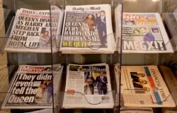 Newspapers are seen for sale in London, Jan. 9, 2020. In a statement Prince Harry and his wife, Meghan, said they are planning "to step back" as senior members of the royal family and "work to become financially independent."