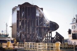 FILE - The bow section of the vehicle carrier Golden Ray, with some of the 4,000 cars still onboard, waits to be towed to a scrap yard, Dec. 1, 2020, in Brunswick, Ga.