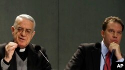 FILE - Vatican spokesman Father Federico Lombardi, left, and Vatican communications adviser Greg Burke present Pope Benedict XVI's Twitter web page to journalists at the Vatican press hall, Dec. 3, 2012. Pope Francis named Burke as his spokesman, July 11, 2016.