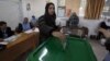 A woman casts her vote at a polling station during the first hours of the Jordanian Parliamentary elections, in Al-Salt, Jordan, January 23, 2013.