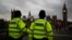 FILE - Police officers patrol Westminster Bridge with the Houses of Parliament in the background, in London, Britain, June 8, 2017.