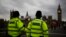 FILE - Police officers patrol Westminster Bridge with the Houses of Parliament in the background, in London, Britain, June 8, 2017.