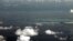 FILE - An aerial photo taken though a glass window of a Philippine military plane shows the alleged ongoing land reclamation by China in the Spratly Islands in the South China Sea, west of Palawan, Philippines.